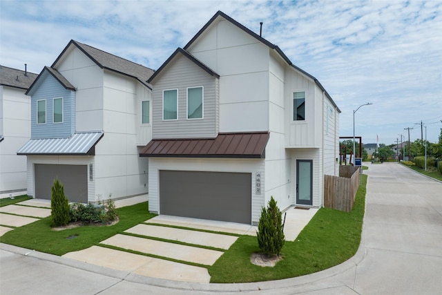 4402 Santorini Ln, Houston, TX 77045 - contemporary house featuring a standing seam roof, concrete driveway, a garage, and a metal roof