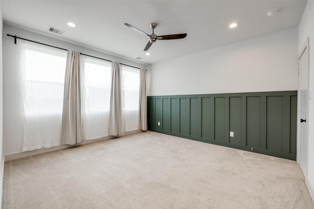 4402 Santorini Ln, Houston, TX 77045 - carpeted empty room featuring a ceiling fan, a smoke detector, wainscoting, recessed lighting, and a decorative wall