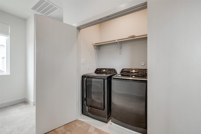 4402 Santorini Ln, Houston, TX 77045 - washroom featuring washing machine and clothes dryer and light carpet