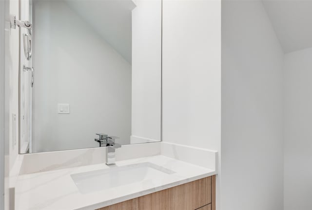 4402 Santorini Ln, Houston, TX 77045 - bathroom featuring vaulted ceiling and vanity