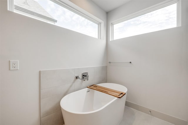 4402 Santorini Ln, Houston, TX 77045 - bathroom with a freestanding tub and tile walls