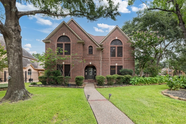 5802 Ashmere Ln, Spring, TX 77379 - view of front facade with brick siding and a front yard