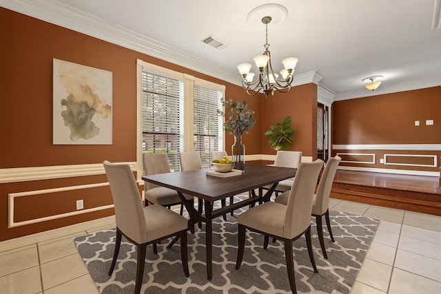 5802 Ashmere Ln, Spring, TX 77379 - dining room featuring light tile patterned floors, a chandelier, crown molding, and a wainscoted wall