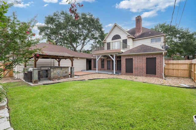 5802 Ashmere Ln, Spring, TX 77379 - rear view of house featuring a balcony, a patio area, a fenced backyard, brick siding, and a chimney