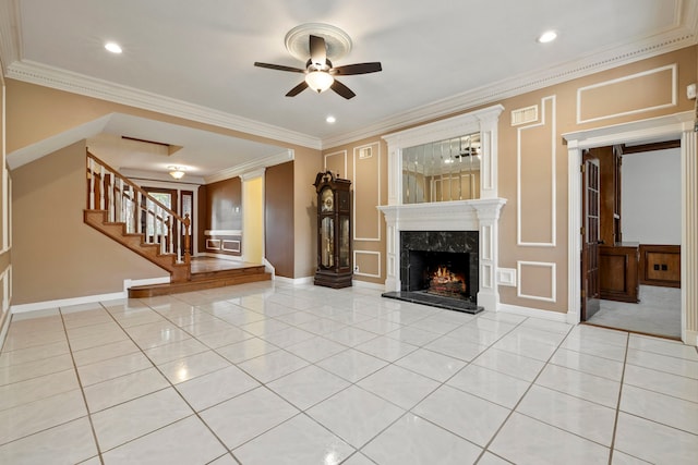 5802 Ashmere Ln, Spring, TX 77379 - unfurnished living room with ceiling fan, a premium fireplace, light tile patterned floors, stairway, and crown molding