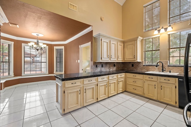 5802 Ashmere Ln, Spring, TX 77379 - kitchen featuring a chandelier, crown molding, tile countertops, backsplash, and a peninsula
