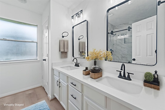 13611 Ortega Ln, Houston, TX 77083 - full bathroom with a marble finish shower, double vanity, and wood finished floors