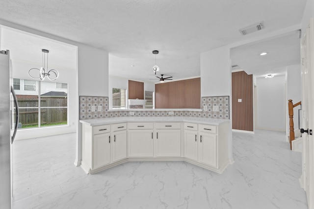 13611 Ortega Ln, Houston, TX 77083 - kitchen featuring freestanding refrigerator, backsplash, a ceiling fan, white cabinets, and light countertops