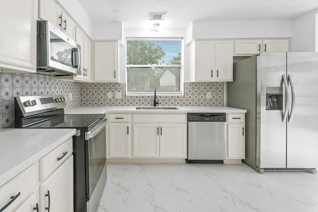 13611 Ortega Ln, Houston, TX 77083 - kitchen with stainless steel appliances, decorative backsplash, light countertops, and light marble finish floors