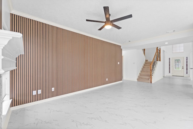 13611 Ortega Ln, Houston, TX 77083 - unfurnished living room with marble finish flooring, stairs, a ceiling fan, wooden walls, and ornamental molding