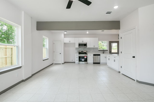 8306 E Tidwell Rd, Houston, TX 77028 - unfurnished living room featuring a ceiling fan and recessed lighting