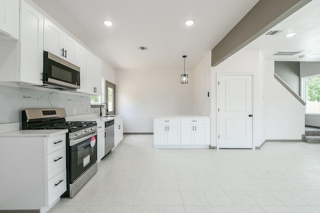 8306 E Tidwell Rd, Houston, TX 77028 - kitchen featuring stainless steel appliances, tasteful backsplash, white cabinets, light countertops, and recessed lighting