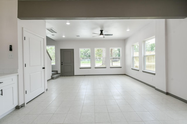 8306 E Tidwell Rd, Houston, TX 77028 - unfurnished living room with ceiling fan, stairs, recessed lighting, and light tile patterned floors