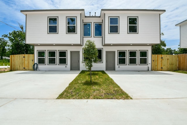 8306 E Tidwell Rd, Houston, TX 77028 - contemporary house featuring concrete driveway and a gate