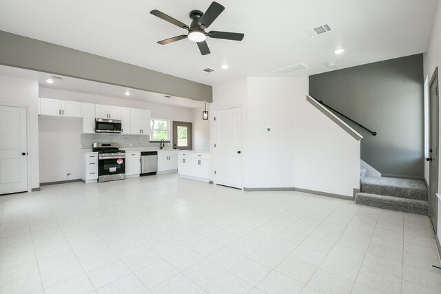8306 E Tidwell Rd, Houston, TX 77028 - unfurnished living room featuring recessed lighting, a ceiling fan, and stairway