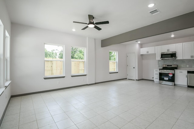 8306 E Tidwell Rd, Houston, TX 77028 - unfurnished living room with a ceiling fan, recessed lighting, and light tile patterned floors