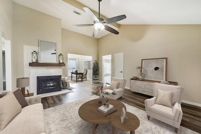 2322 Old Oak Ln, Kingwood, TX 77339 - living room featuring wood finished floors, a ceiling fan, a fireplace, and high vaulted ceiling