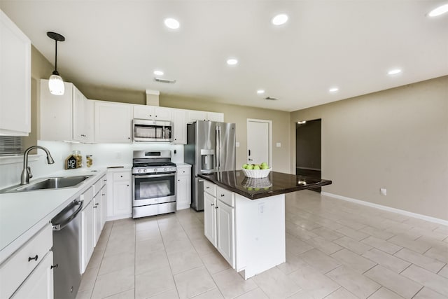 2322 Old Oak Ln, Kingwood, TX 77339 - kitchen with appliances with stainless steel finishes, a center island, white cabinetry, hanging light fixtures, and recessed lighting