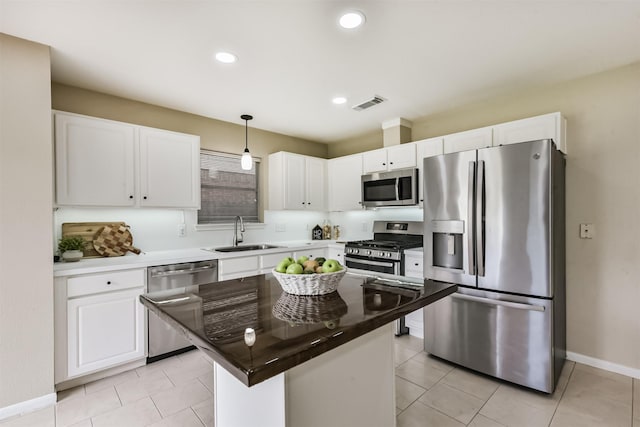 2322 Old Oak Ln, Kingwood, TX 77339 - kitchen with stainless steel appliances, white cabinetry, pendant lighting, a kitchen island, and recessed lighting