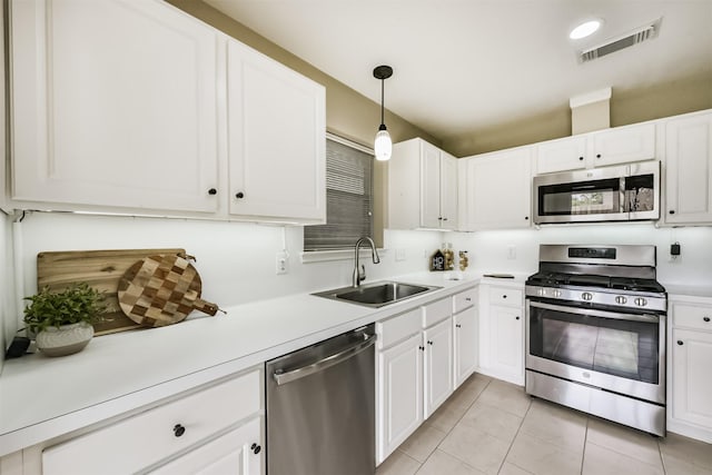 2322 Old Oak Ln, Kingwood, TX 77339 - kitchen with appliances with stainless steel finishes, light tile patterned flooring, light countertops, and white cabinets