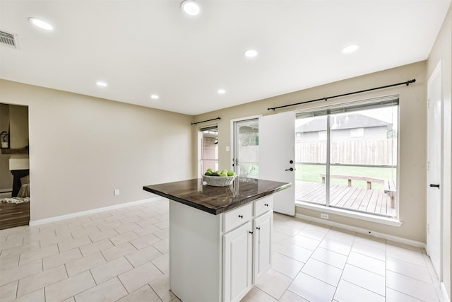 2322 Old Oak Ln, Kingwood, TX 77339 - kitchen featuring dark countertops, healthy amount of natural light, a center island, recessed lighting, and white cabinets