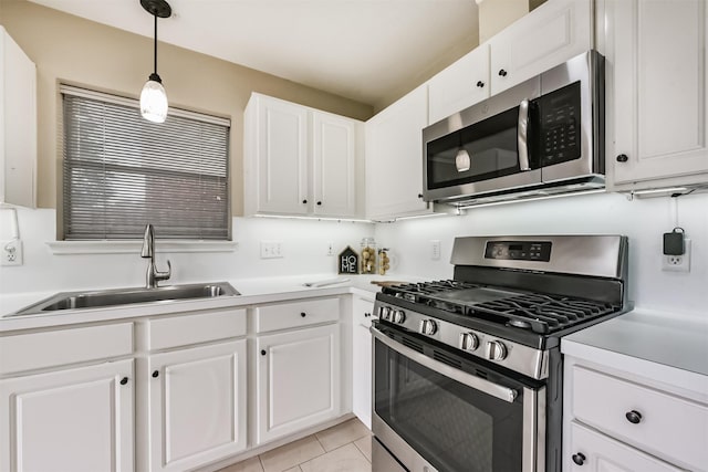 2322 Old Oak Ln, Kingwood, TX 77339 - kitchen featuring stainless steel appliances, white cabinetry, light countertops, decorative light fixtures, and light tile patterned floors