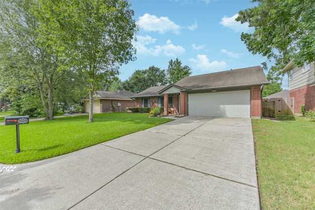 2322 Old Oak Ln, Kingwood, TX 77339 - view of front facade featuring a garage, brick siding, and driveway
