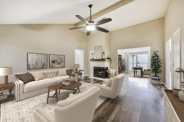 2322 Old Oak Ln, Kingwood, TX 77339 - living room with high vaulted ceiling, a ceiling fan, a fireplace with flush hearth, dark wood-style flooring, and beamed ceiling
