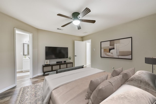 2322 Old Oak Ln, Kingwood, TX 77339 - bedroom featuring wood finished floors and a ceiling fan