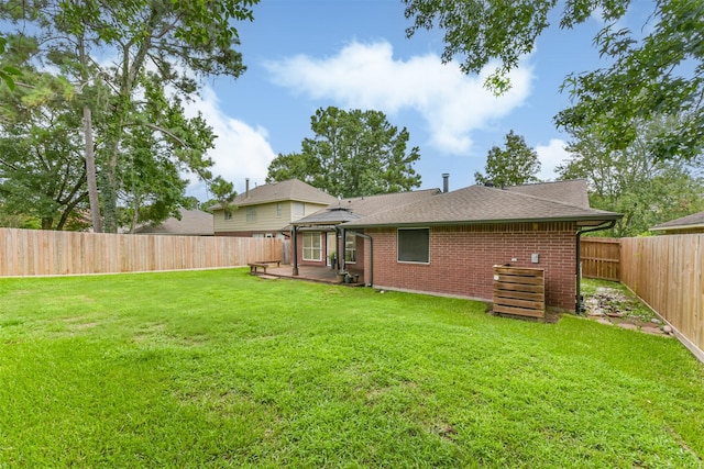 2322 Old Oak Ln, Kingwood, TX 77339 - rear view of house with a gazebo, a fenced backyard, brick siding, and roof with shingles