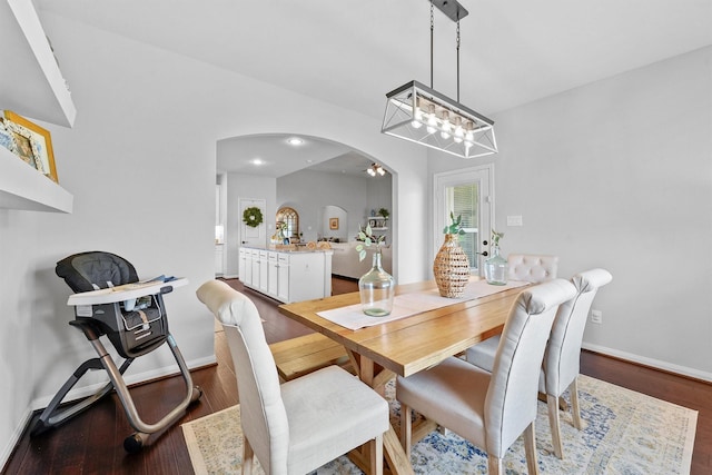 22402 Threefold Ridge Dr, Hockley, TX 77447 - dining space featuring arched walkways, wood finished floors, a chandelier, and ceiling fan