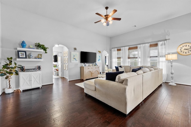 22402 Threefold Ridge Dr, Hockley, TX 77447 - living room featuring arched walkways, ceiling fan, and dark wood-style flooring