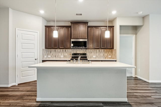 7222 Melrose Ln, Rosharon, TX 77583 - kitchen with stainless steel microwave, dark wood-style floors, light countertops, and recessed lighting