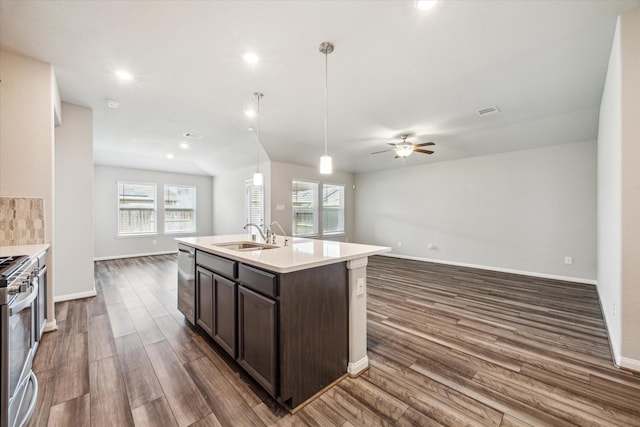 7222 Melrose Ln, Rosharon, TX 77583 - kitchen featuring open floor plan, dark wood finished floors, dark brown cabinetry, a ceiling fan, and healthy amount of natural light