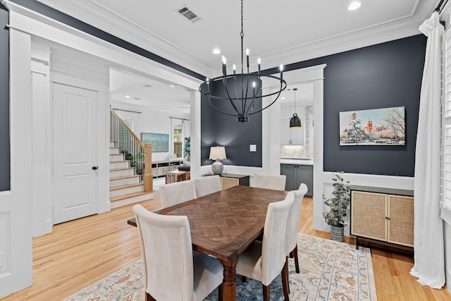 1603 Columbia St, Houston, TX 77008 - dining space with a chandelier, ornamental molding, stairway, light wood-style flooring, and recessed lighting