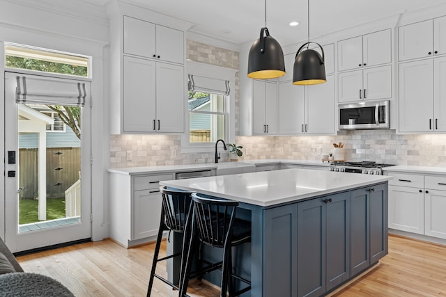 1603 Columbia St, Houston, TX 77008 - kitchen with stainless steel appliances, light countertops, healthy amount of natural light, crown molding, and recessed lighting