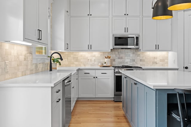 1603 Columbia St, Houston, TX 77008 - kitchen with stainless steel appliances, light countertops, light wood-style flooring, and backsplash