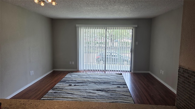 2818 S Bartell Dr Unit 13, Houston, TX 77054 - unfurnished room with wood finished floors, a chandelier, and a textured ceiling