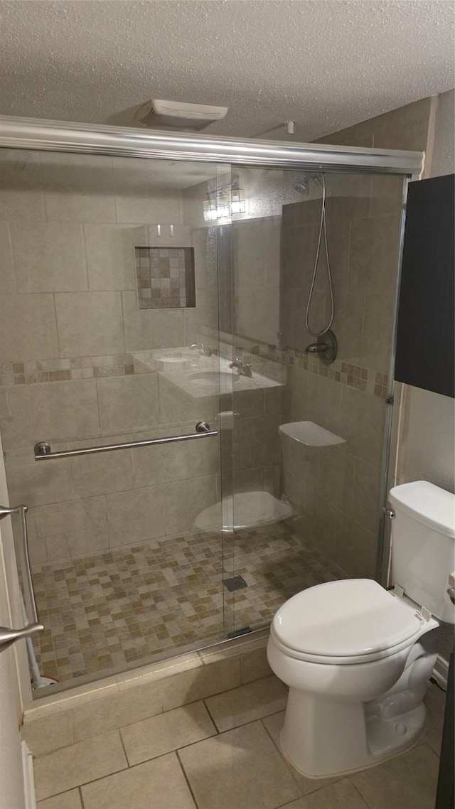 2818 S Bartell Dr Unit 13, Houston, TX 77054 - bathroom with a textured ceiling, a shower stall, and tile patterned floors