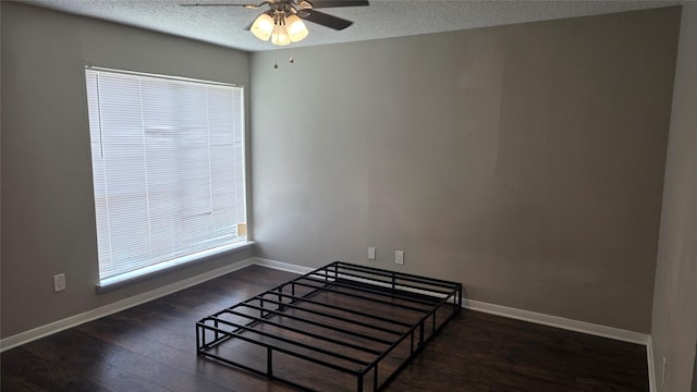 2818 S Bartell Dr Unit 13, Houston, TX 77054 - unfurnished bedroom featuring wood finished floors, a textured ceiling, and a ceiling fan