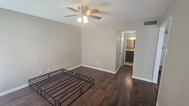 2818 S Bartell Dr Unit 13, Houston, TX 77054 - unfurnished bedroom featuring dark wood-style floors, a textured ceiling, and ceiling fan