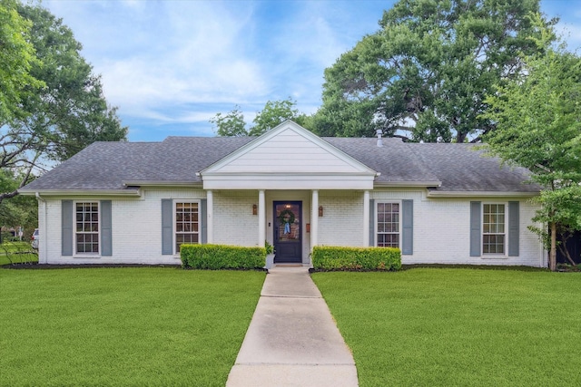 7730 Skyline Dr, Houston, TX 77063 - view of front facade with a front yard, brick siding, and a shingled roof