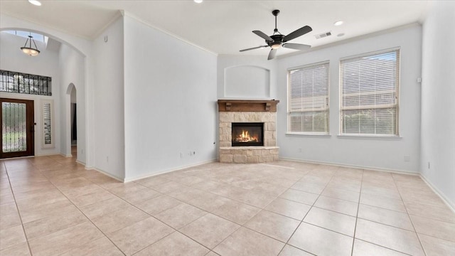 4627 Western Brook Dr, Spring, TX 77388 - unfurnished living room featuring arched walkways, light tile patterned floors, ornamental molding, plenty of natural light, and recessed lighting