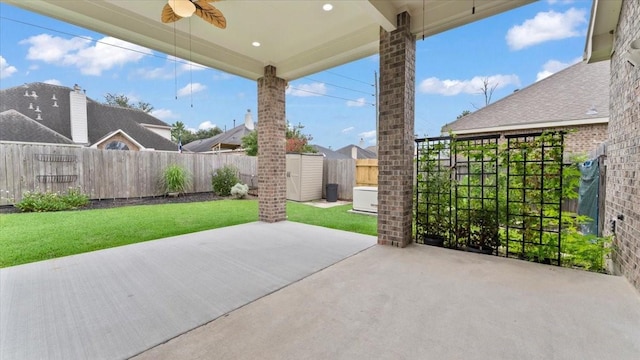 4627 Western Brook Dr, Spring, TX 77388 - fenced backyard featuring ceiling fan, a storage unit, and a patio