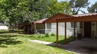 10005 Cypress N Houston Rd, Houston, TX 77070 - view of property exterior with a lawn