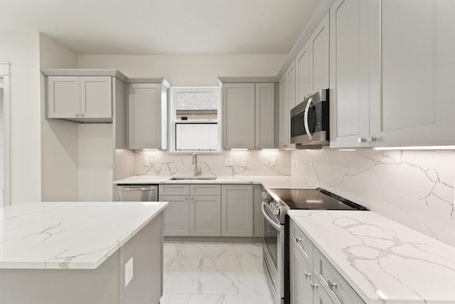 10406 Grove Row Ave, Richmond, TX 77407 - kitchen with appliances with stainless steel finishes, light marble finish floors, decorative backsplash, light stone countertops, and gray cabinets