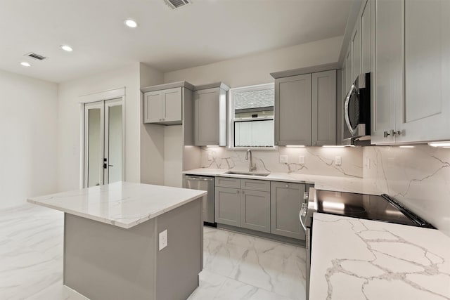 10406 Grove Row Ave, Richmond, TX 77407 - kitchen with appliances with stainless steel finishes, gray cabinets, light marble finish flooring, recessed lighting, and light stone counters