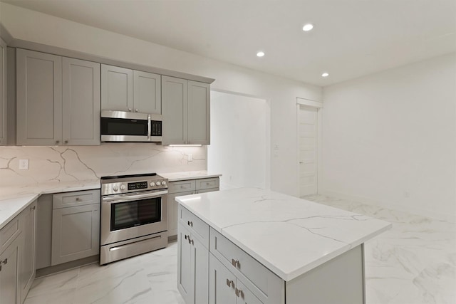 10406 Grove Row Ave, Richmond, TX 77407 - kitchen featuring appliances with stainless steel finishes, light marble finish flooring, gray cabinetry, recessed lighting, and light stone countertops