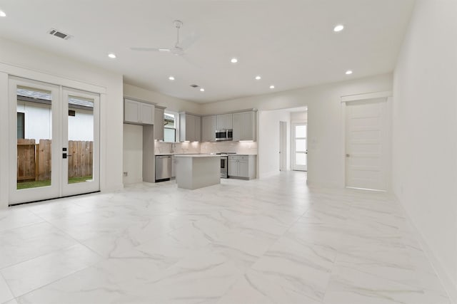 10406 Grove Row Ave, Richmond, TX 77407 - kitchen featuring stainless steel appliances, gray cabinetry, recessed lighting, a center island, and ceiling fan