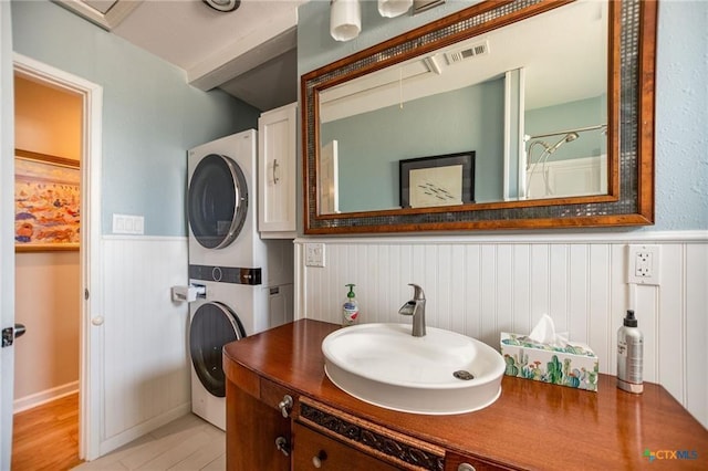 40 Sailfish Lndg, Port Lavaca, TX 77979 - bathroom with stacked washing machine and dryer, a wainscoted wall, vanity, and a shower